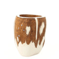 A close-up view of a handcrafted mate gourd against a plain white background. It features a rustic brown wood and creamy white design resembling a traditional South American cow or horse hide pattern. The upper wooden section includes an inlay of four small silver metal dots representing the Southern Cross constellation.