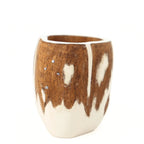 A close-up view of a handcrafted mate gourd against a plain white background. It features a rustic brown wood and creamy white design resembling a traditional South American cow or horse hide pattern. The upper wooden section includes an inlay of four small silver metal dots representing the Southern Cross constellation.