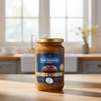A jar of San Ignacio Dulce de Leche Traditional (450g) in a soft-focus kitchen counter setting.