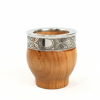 Wooden mate gourd with an intricately patterned stainless steel rim featuring filigree and a central polished oval medallion, isolated on a white background.