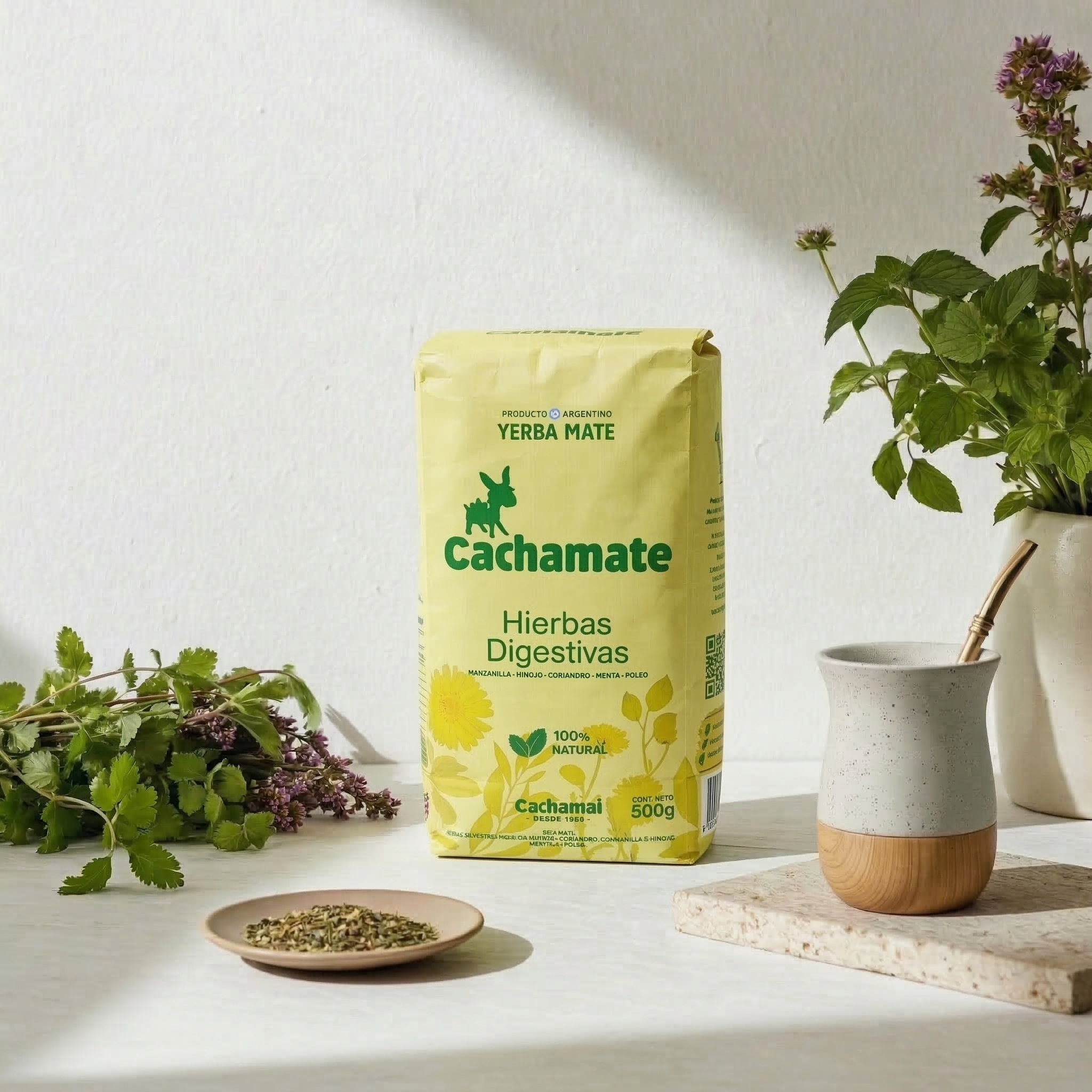 Cachamate Yerba Mate with Digestive Herbs - 500g yellow package lifestyle shot with mate gourd and bombilla.