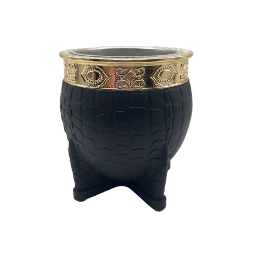 Front view of the Chacarera mate gourd featuring a textured black exterior and an ornate gold-finished stainless steel rim