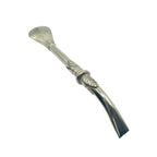 Profile view of the curved pico de loro mouthpiece with intricate leaf detailing on the premium Alpaca Bombillón.