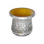 Premium handmade yerba mate cup shown from a high angle, beautifully highlighting the warm natural wood interior, the wide flared metal rim, and the intricate floral repoussé exterior.