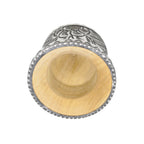 A deep top-down view into the Huella artisan gourd, showcasing the smooth, natural wood core and the carefully textured metal rim that defines this premium handmade piece.