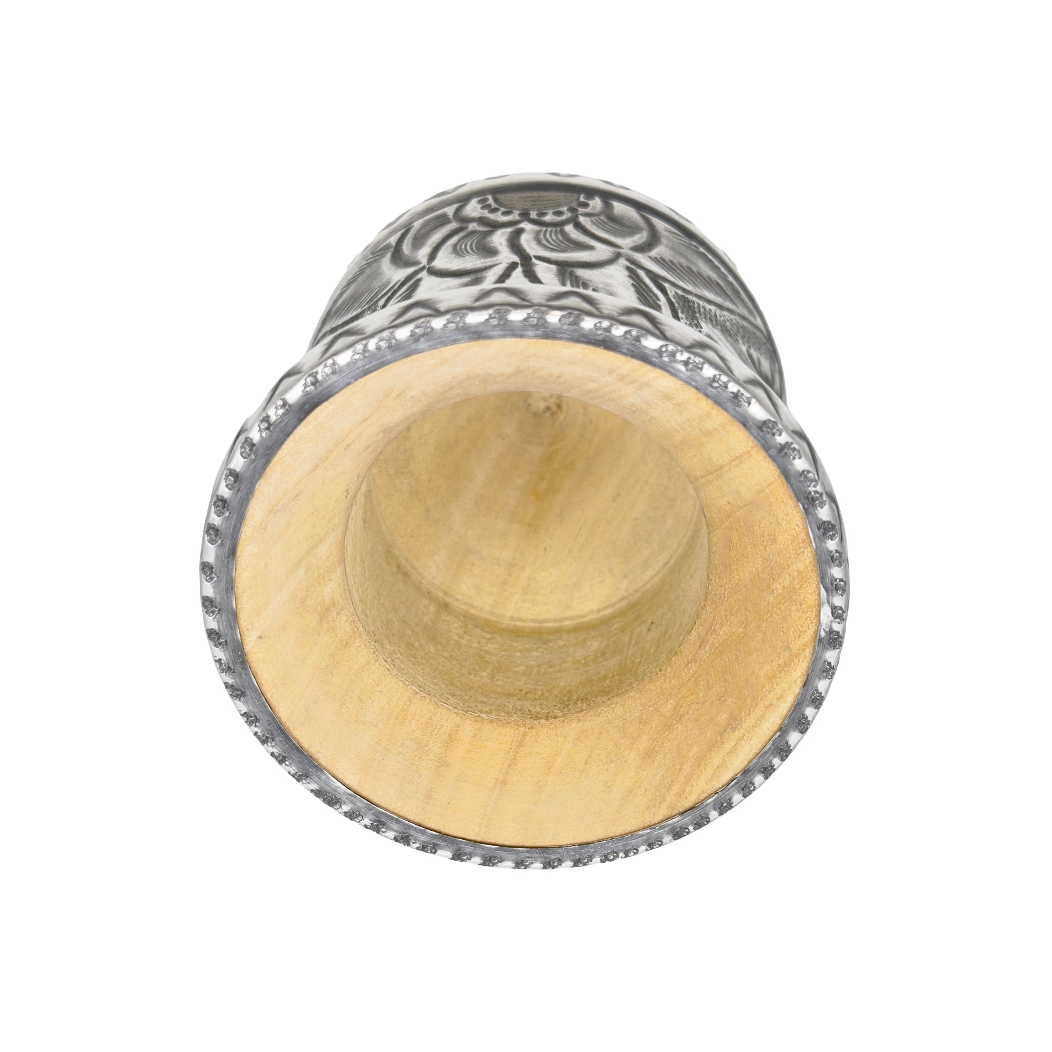 A deep top-down view into the Huella artisan gourd, showcasing the smooth, natural wood core and the carefully textured metal rim that defines this premium handmade piece.
