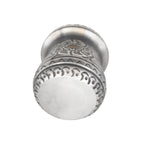 A bottom-up view of the premium handmade yerba mate cup, displaying the smooth metal base surrounded by continuous, intricate repoussé detailing along the lower edge.
