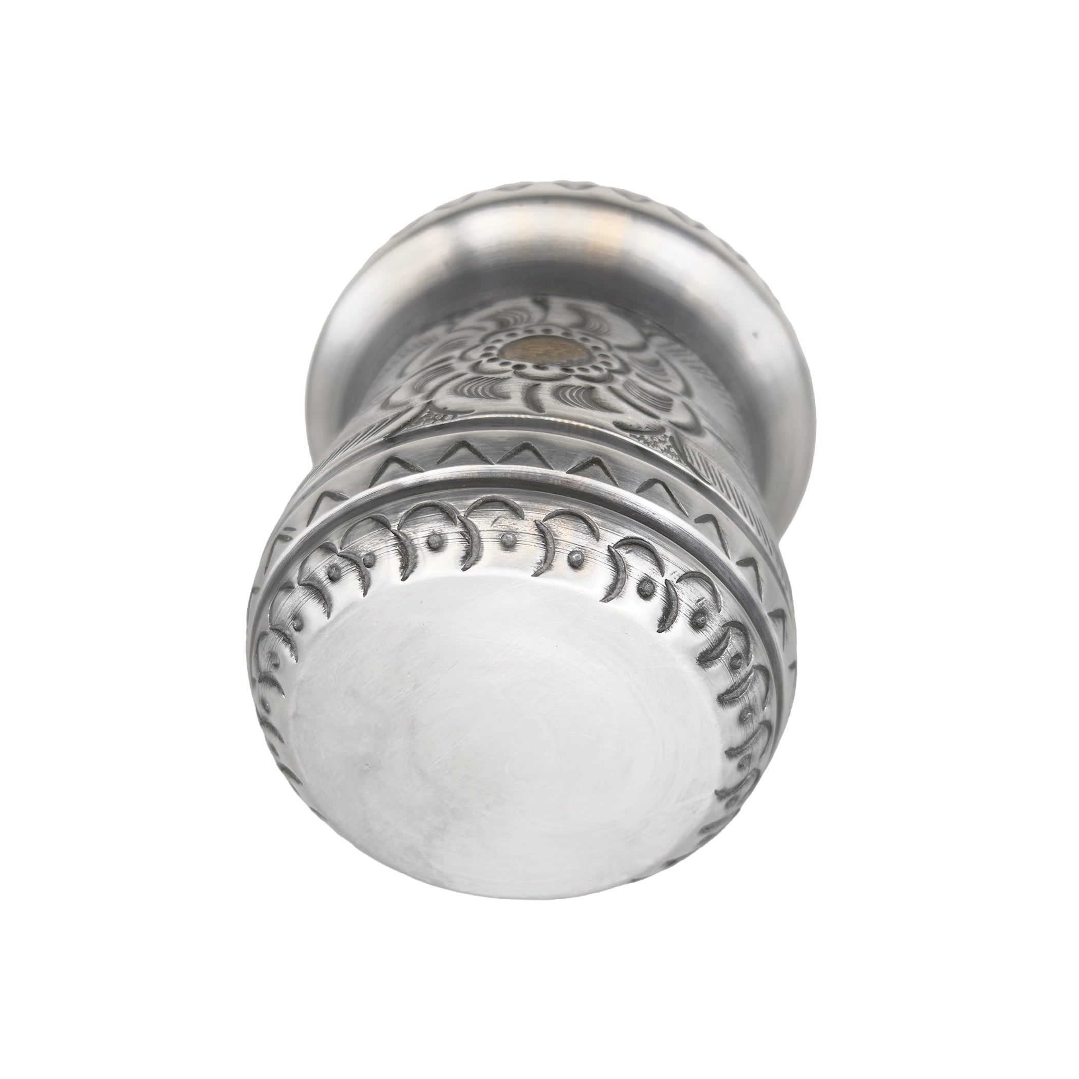 A bottom-up view of the premium handmade yerba mate cup, displaying the smooth metal base surrounded by continuous, intricate repoussé detailing along the lower edge.