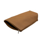 Angled flat lay view. A handcrafted leather yerbera (yerba mate bag) in Adobe Brown rests horizontally against a white background. The top zipper is partially open, showcasing the smooth leather texture and revealing the dark interior storage compartment.