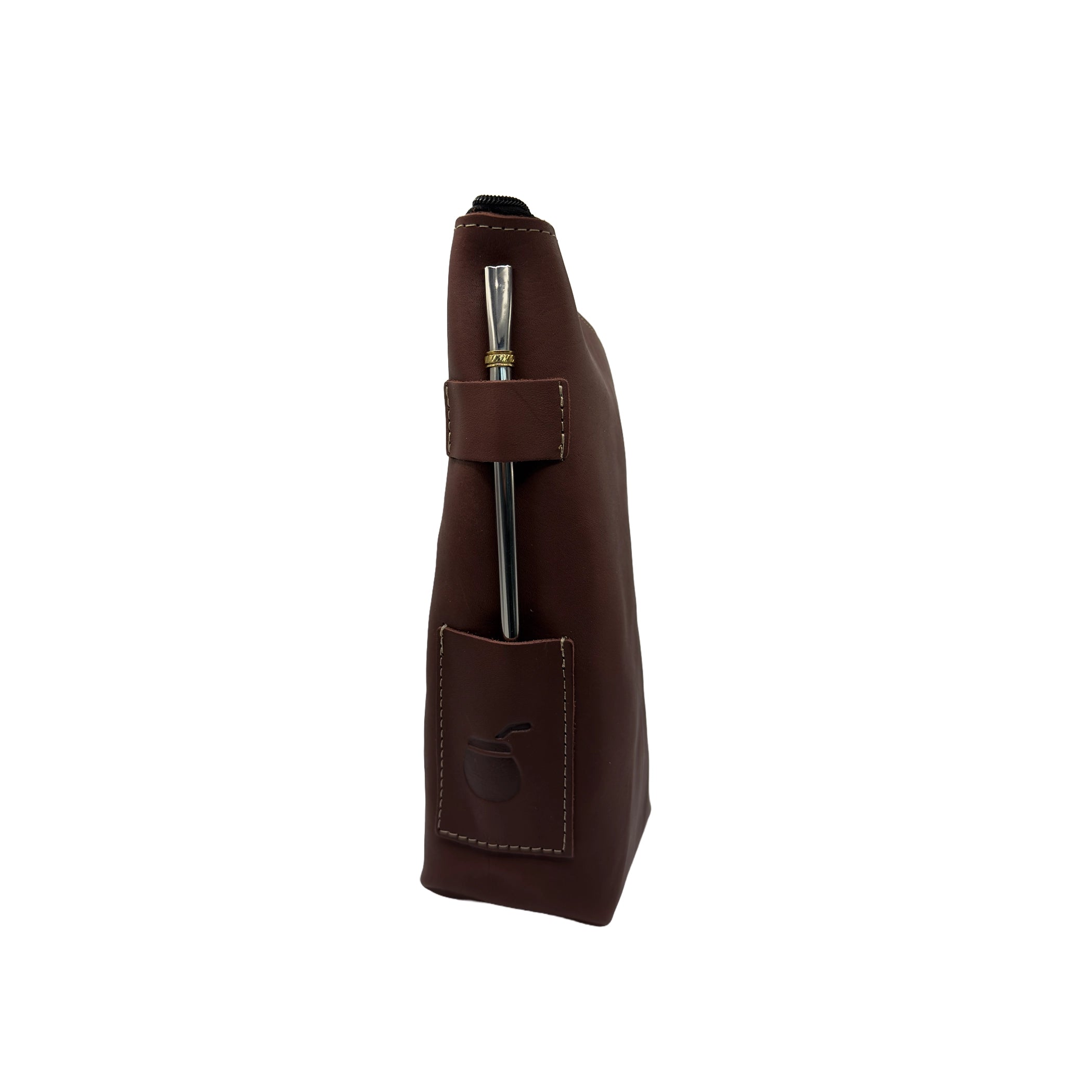 side profile view. A closed handcrafted leather yerbera in reddish-brown Alazan color stands vertically, showcasing the sturdy integrated side loop with a metal bombilla inserted and the embossed mate gourd design on the lower pocket, both for display (bombilla sold separately).