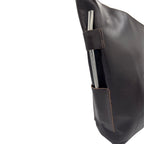 Close-up detail of the handcrafted leather bombilla holder on the Pampero pouch, ensuring secure transport.