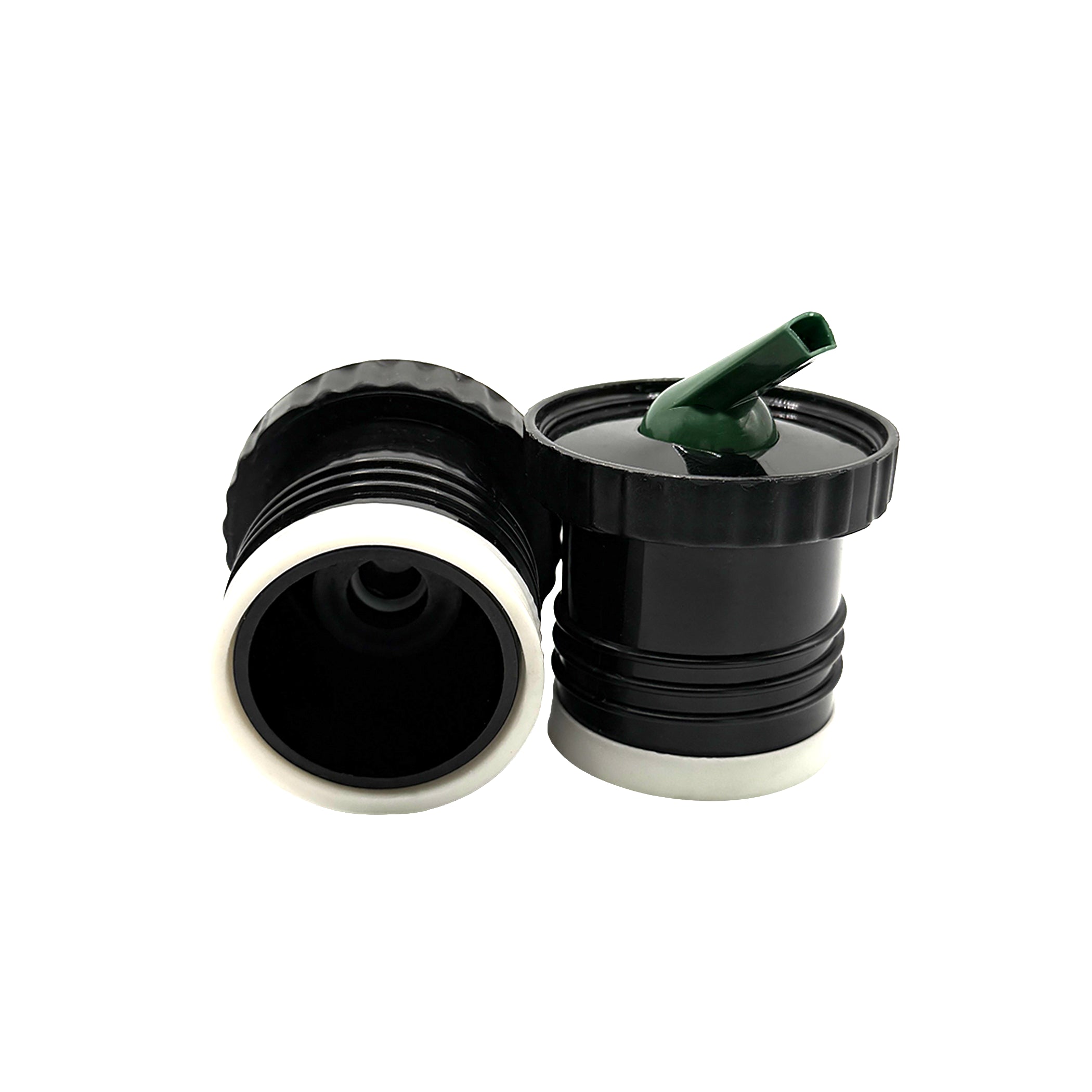 A close-up photograph displaying the two-pack of black & forest green Sur 360° stoppers on a white background. One stopper is positioned to show its internal screw-on thread and central red valve, while the other stands upright, revealing its distinctive precision pouring spout