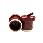 A close-up photograph displaying the two-pack of terracota red Sur 360° stoppers on a white background. One stopper is positioned to show its internal screw-on thread and central red valve, while the other stands upright, revealing its distinctive precision pouring spout