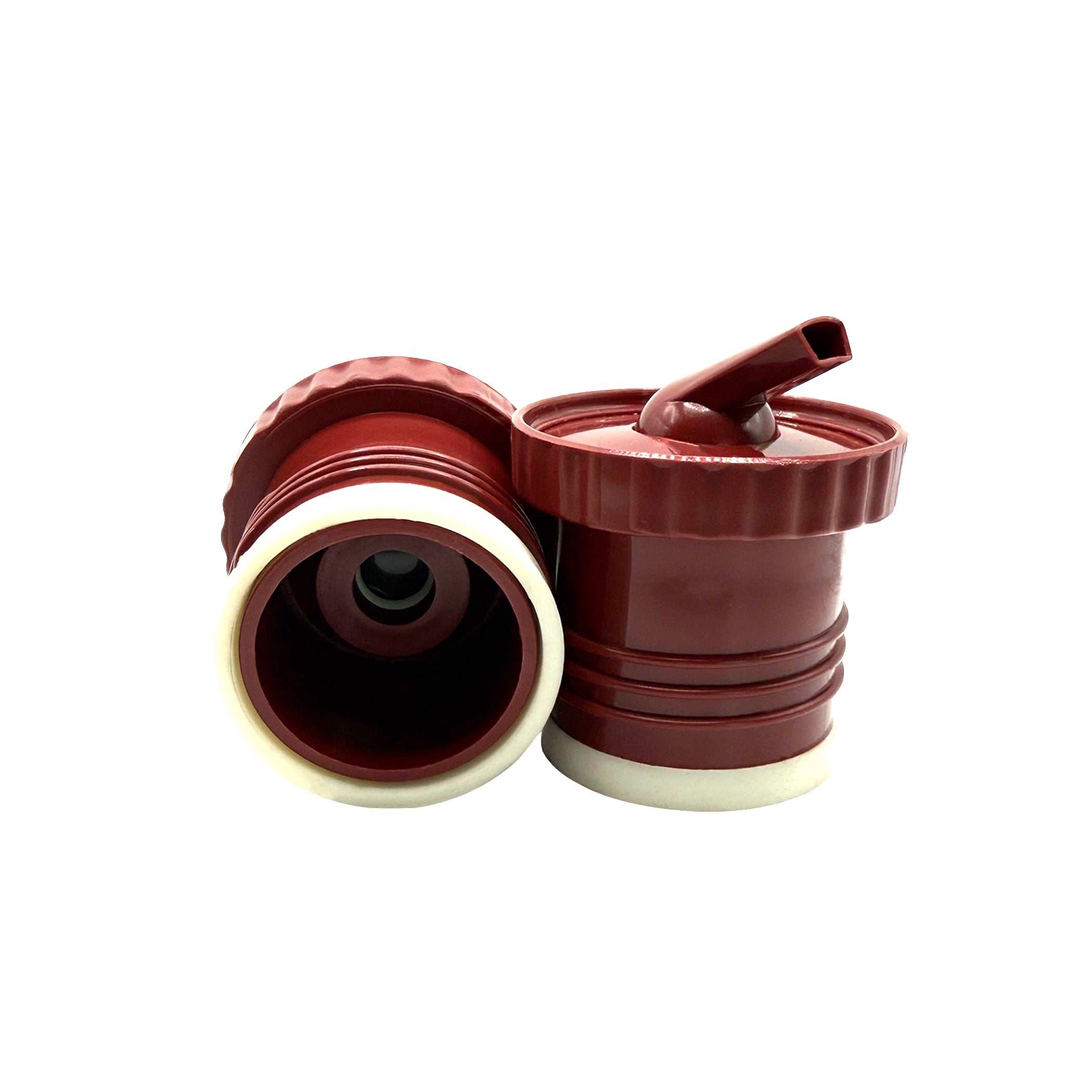 A close-up photograph displaying the two-pack of terracota red Sur 360° stoppers on a white background. One stopper is positioned to show its internal screw-on thread and central red valve, while the other stands upright, revealing its distinctive precision pouring spout