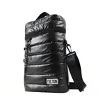 An angled, three-quarter view of the YELTON black puffer mate bag on a pure white background. This angle emphasizes the bag's rectangular structure, the depth of the quilted padding, the attached crossbody strap, and the top carrying handle.