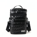 Front view of a black quilted puffer-style mate carrying bag by the brand YELTON against a plain white background. The image highlights the horizontal puff stitching, a top grab handle, a main zipper closure with a metal D-ring attachment, an adjustable black shoulder strap, and a white rectangular YELTON logo patch on the bottom right.